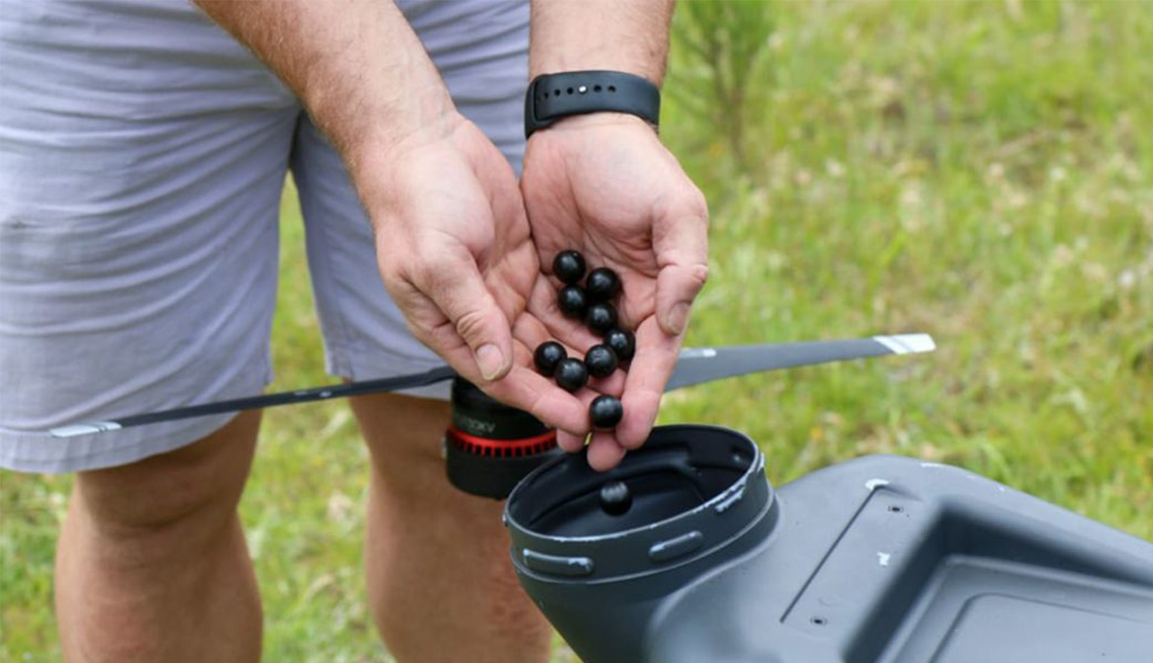 Un operador de dron carga las cápsulas con las semillas en un dron. | WWF-Australia